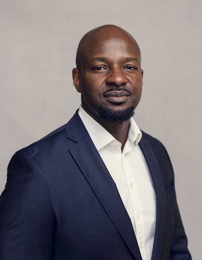 Alex Okosi Headshot bio