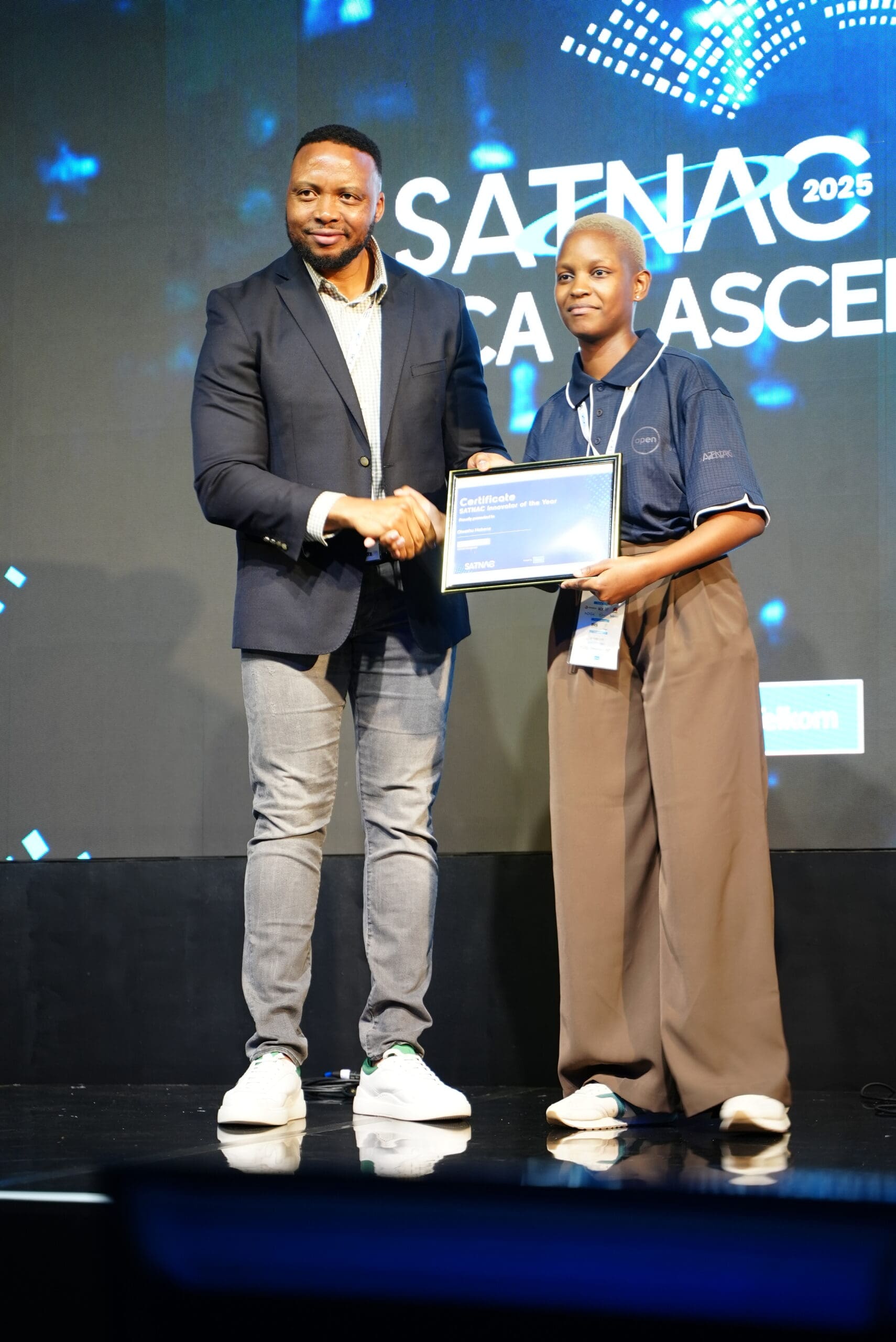 Mr Sello Mmakau (left), Telkom Group Chief Digital Officer, congratulates Olwethu Mabena (right), an Eduvos student, on her SATNAC Innovator of the Year Award.